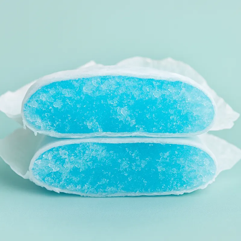 Close-up of diaper core cut open, showing blue superabsorbent polymer (first-use SAP)