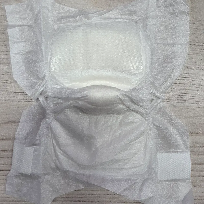 Open preemie diaper showing soft topsheet, absorbent core and leg cuffs.