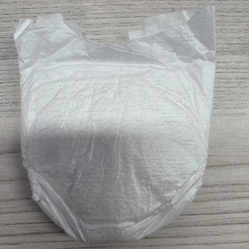 Folded premature baby diaper with plain white backsheet.