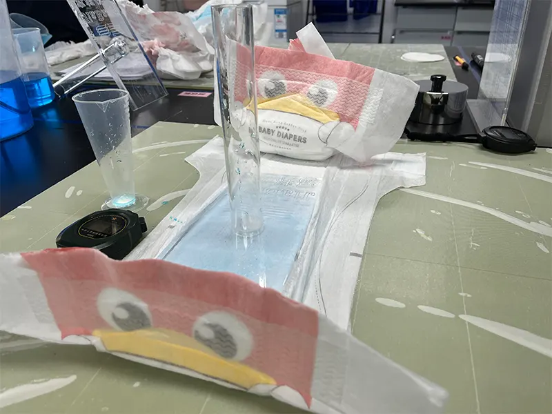 Re-wet test—cylinder of liquid on diaper absorbent core