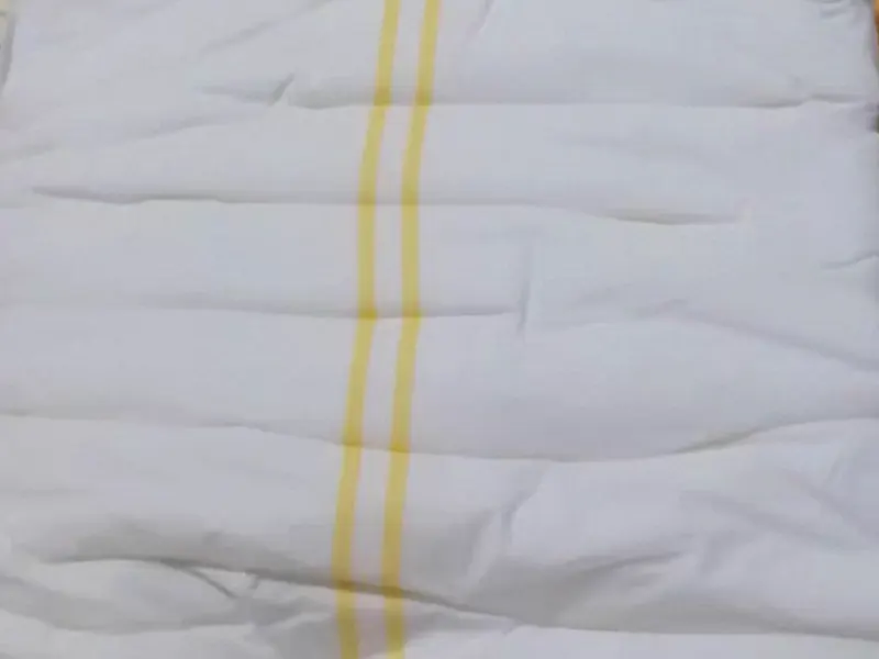Yellow wetness indicator lines on the diaper surface to signal when to change.