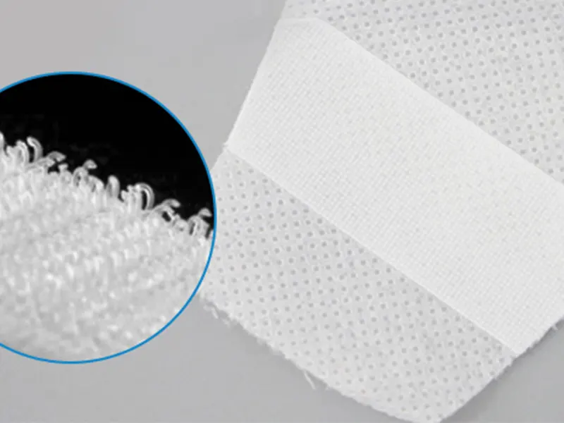 Magic hook waist tape detail with magnified loop surface for easy fastening.